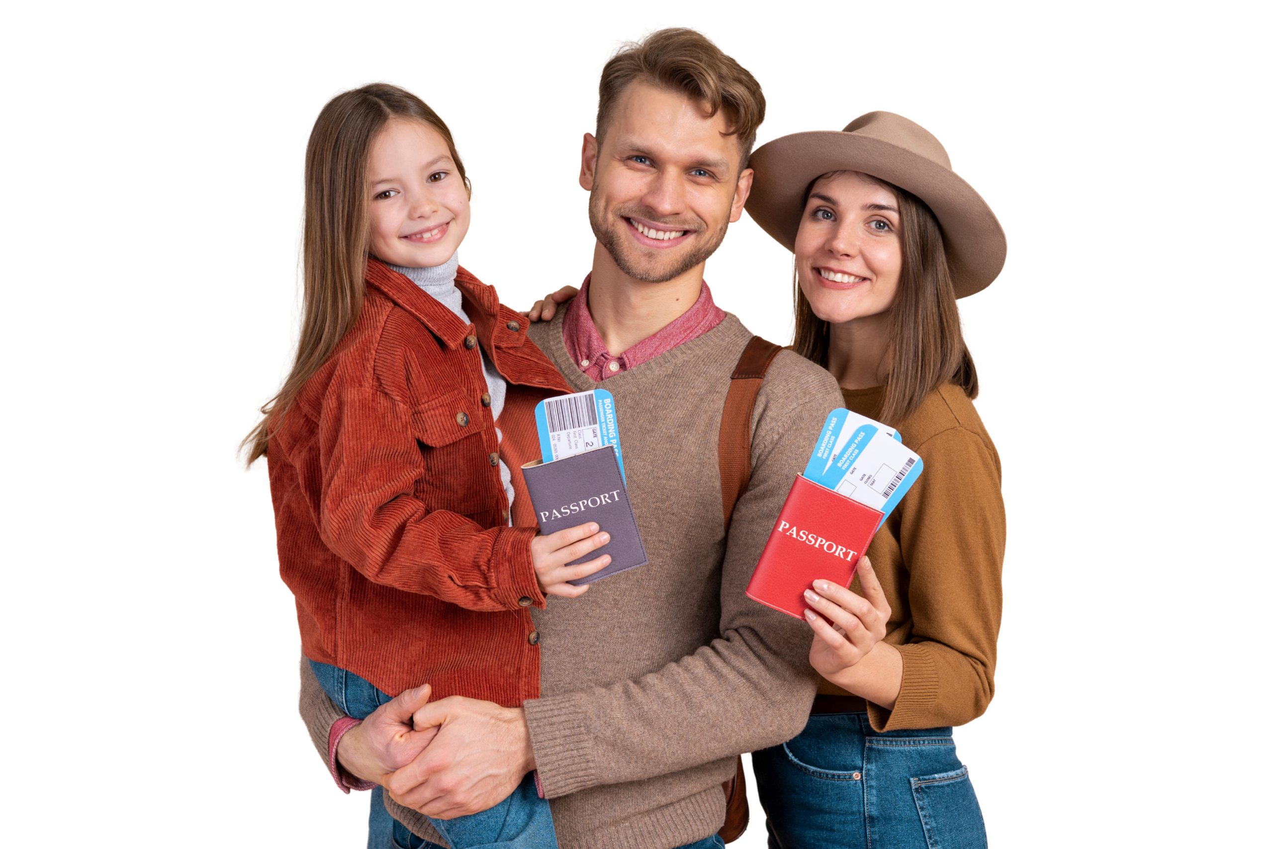 A studio portrait of a smiling family of three against a white background, featuring a father holding his young daughter who has a purple passport, and a mother wearing a hat holding a red passport with airplane boarding passes.